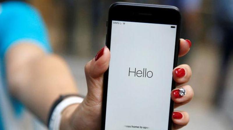 Ayano Tominaga poses with her Apples new iPhone 7 after purchasing it at the Apple Store at Tokyos Omotesando shopping district, Japan, September 16, 2016. REUTERS/Issei Kato