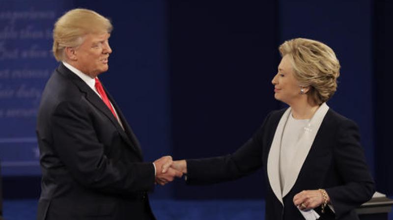 Republican presidential nominee Donald Trump shakes hands with Democratic presidential nominee Hillary Clinton following the second presidential debate at Washington University in St. Louis. (Photo: AP)