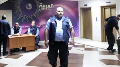 Security staff members stand guard at the entrance of the offices of Saudi-owned Al-Arabiya news channel today in Beirut. (Photo: AFP)