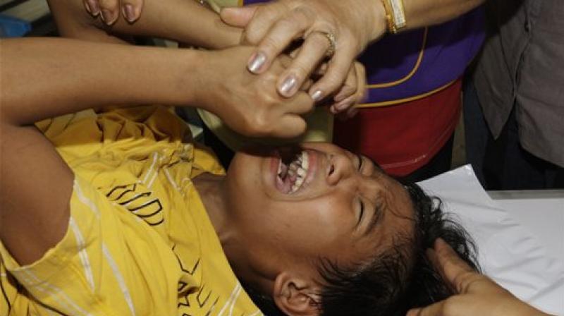 A boy cries in pain as others try to prevent him from moving too much during a mass circumcision in Marikina city, east of Manila, Philippines. (Photo: AP)