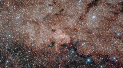 Hubble's infrared vision pierced the dusty heart of our Milky Way galaxy to reveal more than half a million stars at its core. At the very hub of our galaxy, this star cluster surrounds the Milky Way's central supermassive black hole, which is about 4 million times the mass of our sun. (Photo: NASA)
