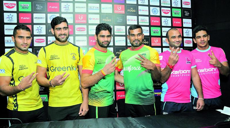 Telugu Titans captain Rahul Chaudhari (from left), Pradeep Narwal and Dharmaraj Cheralathan of Patna Pirates and Jaipur Pink Panthers skipper Jasvir Singh flash victory signs on Thursday, eve of Pro Kabaddi semifinals in Hyderabad.