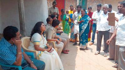 Officials holding a meeting with Dalits at Singaranahalli in Holenarsipur taluk of Hassan district on Friday 	– DC