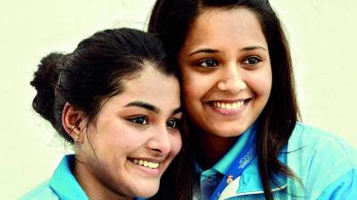 Squash star Dipika Pallikal (right) and teammate Sunayna Kuruvilla pose for photographs after defeating Pakistan in the final of the women’s team event at the 12th South Asian Games in Guwahati on Wednesday. (Photo: AP)