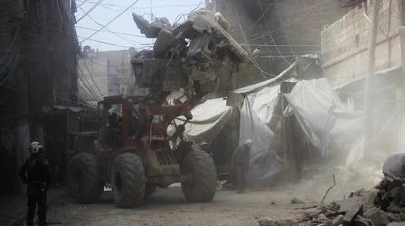 In this picture provided by the Syrian Civil Defense group known as the White Helmets, Syrian Civil Defense workers search through the rubble in rebel-held eastern Aleppo. In this picture provided by the Syrian Civil Defense group known as the White Helmets, Syrian Civil Defense workers search through the rubble in rebel-held eastern Aleppo.