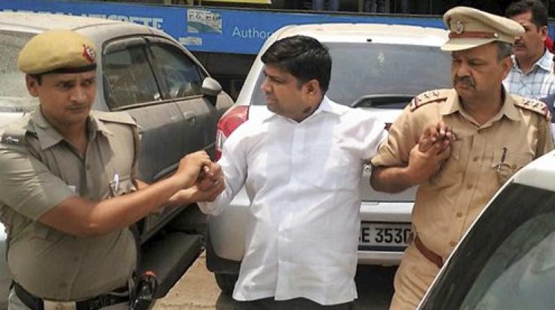 AAP MLA Dinesh Mohaniya being escorted away by the police. (Photo: PTI)