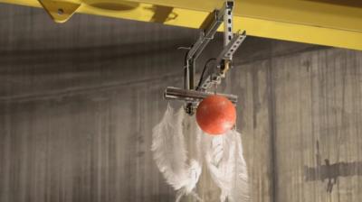 A bowling ball and a feather being dropped at the same time 