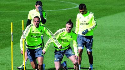 Real Madrid’s Gareth Bale (second from right) sprints alongside Danilo during a training session in Madrid on Friday, eve of their Spanish league match — dubbed El Clasico — against Barcelona. (Photo: AP)