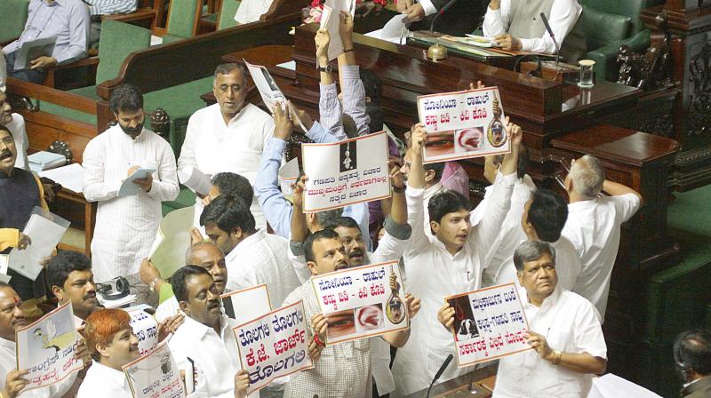 BJP and JD(S) MLAs protest in the Assembly  on Friday seeking Ministers K.J. Georges resignation in connection with DySP suicide case. (Photo: DC)