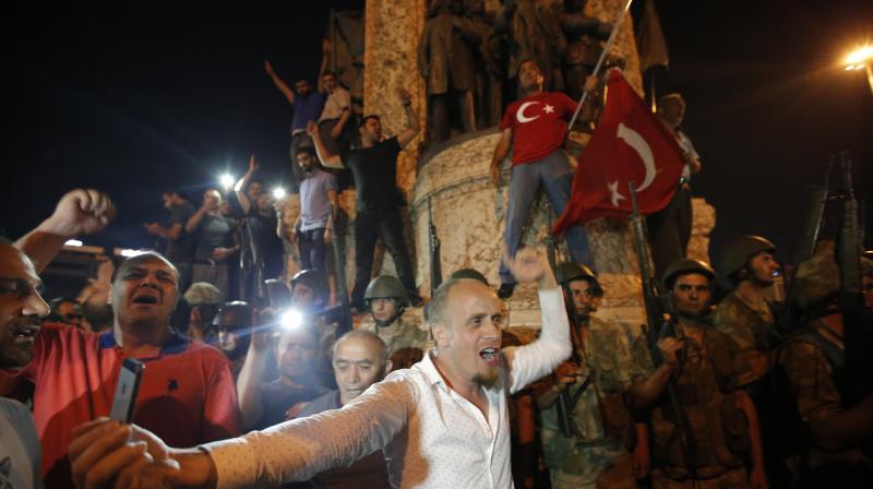 Supporters of Turkeys President Recep Tayyip Erdogan protest in front of soldiers in Istanbuls Taksim square, early Saturday. (Photo: AP) Supporters of Turkeys President Recep Tayyip Erdogan protest in front of soldiers in Istanbuls Taksim square, early Saturday. (Photo: AP)