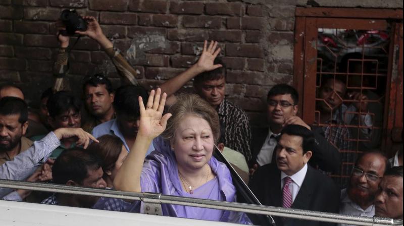 Bangladeshs former prime minister Khaleda Zia, center, waves at her supporters as she leaves a court after a hearing in Dhaka on Wednesday. (Photo: AP)