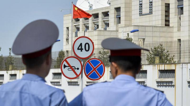 Kyrgyz police officers look at the Chinese Embassy in Bishkek, Kyrgyzstan. (Photo: AP) Kyrgyz police officers look at the Chinese Embassy in Bishkek, Kyrgyzstan. (Photo: AP)