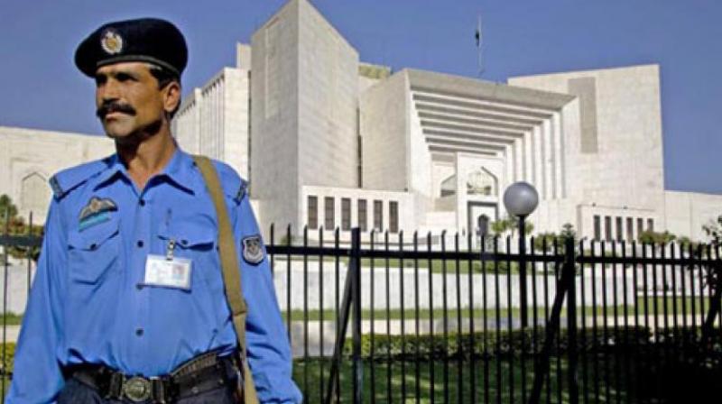 An armed security guard stands outside the Supreme Court of Pakistan. (Photo: AP) An armed security guard stands outside the Supreme Court of Pakistan. (Photo: AP)