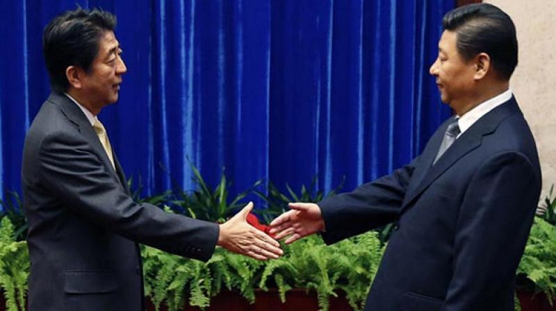 China's President Xi Jinping (right) greets Japan's Prime Minister Shinzo Abe. (Photo: AP) China's President Xi Jinping (right) greets Japan's Prime Minister Shinzo Abe. (Photo: AP)