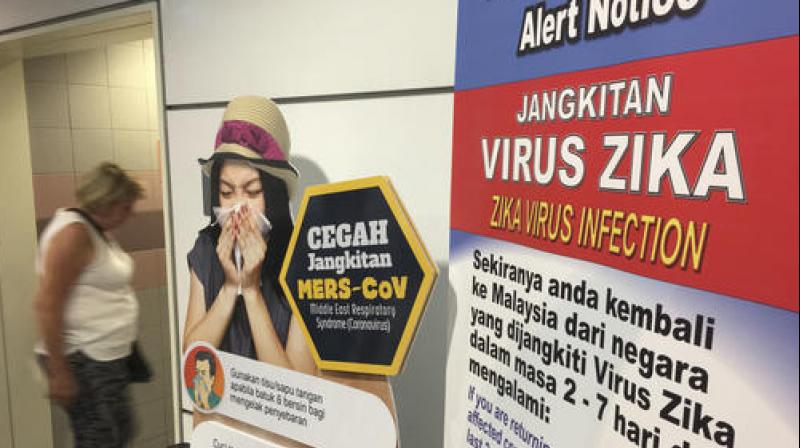 A traveller walks past a travel advisory on the Zika virus infection in Kuala Lumpur International Airport in Sepang. (Photo: AP) A traveller walks past a travel advisory on the Zika virus infection in Kuala Lumpur International Airport in Sepang. (Photo: AP)