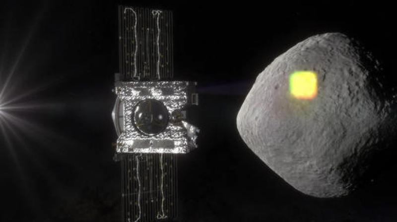 This artist's rendering made available by NASA in July 2016 shows the mapping of the near-Earth asteroid Bennu by the OSIRIS-REx spacecraft. The spacecraft will spend a year surveying Bennu before collecting a sample that will be returned to Earth for analysis. (NASA/Goddard/University of Arizona via AP) This artist's rendering made available by NASA in July 2016 shows the mapping of the near-Earth asteroid Bennu by the OSIRIS-REx spacecraft. The spacecraft will spend a year surveying Bennu before collecting a sample that will be returned to Earth for analysis. (NASA/Goddard/University of Arizona via AP)