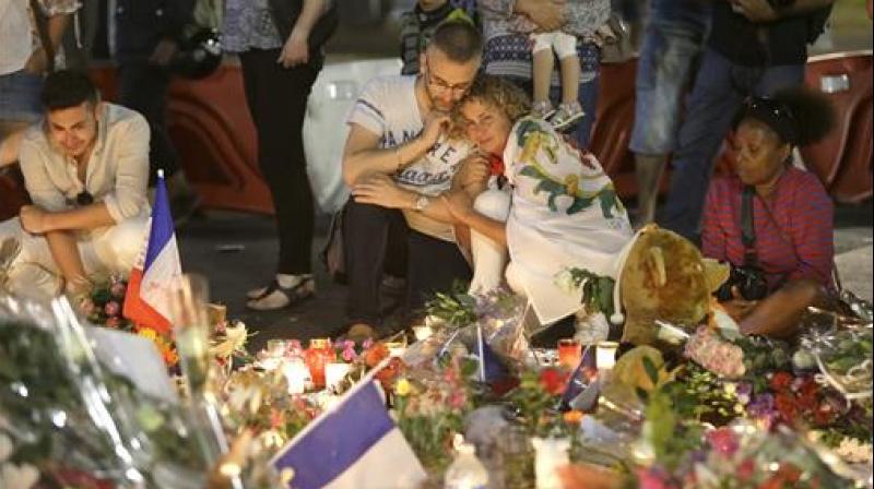 People lay flowers and light candles to honor the victims of an attack, on the Promenade des Anglais, near the area where a truck mowed through revelers in Nice, southern France. (Photo: AP) People lay flowers and light candles to honor the victims of an attack, on the Promenade des Anglais, near the area where a truck mowed through revelers in Nice, southern France. (Photo: AP)