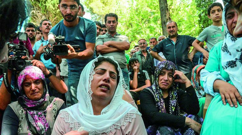 Women cry during a funeral for a victim of an attack on a wedding party that left 54 dead in Gaziantep in southeastern Turkey on Monday. (Photo: AFP) Women cry during a funeral for a victim of an attack on a wedding party that left 54 dead in Gaziantep in southeastern Turkey on Monday. (Photo: AFP)