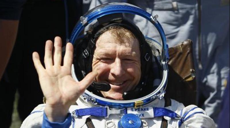 Member of the International Space Station (ISS) crew Britain's Tim Peake waves after landing near the town of Dzhezkazgan, Kazakhstan, Saturday, June 18, 2016. A three-person crew from the International Space Station has landed safely in the sun-drenched steppes of Kazakhstan. (Shamil Zhumatov/Pool Photo via AP) Member of the International Space Station (ISS) crew Britain's Tim Peake waves after landing near the town of Dzhezkazgan, Kazakhstan, Saturday, June 18, 2016. A three-person crew from the International Space Station has landed safely in the sun-drenched steppes of Kazakhstan. (Shamil Zhumatov/Pool Photo via AP)