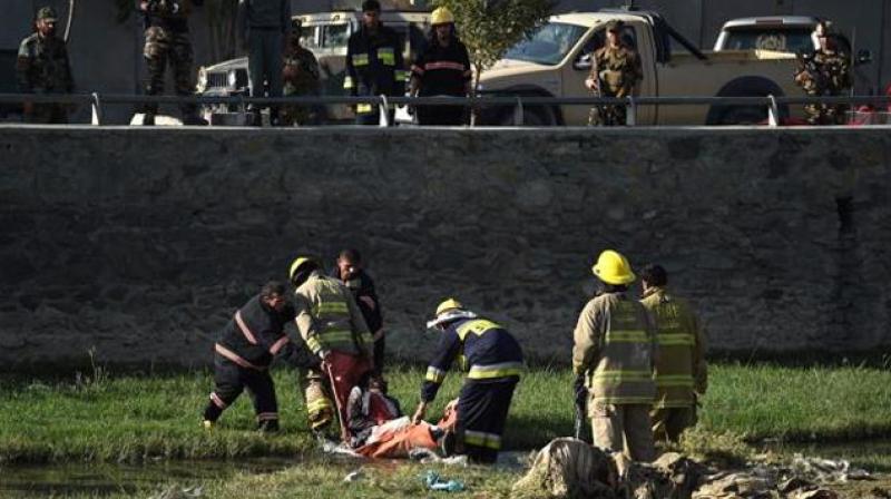 Afghan security personnel and firemen recover a body from the scene of a twin suicide bombing near the Ministry of Defence in Kabul. (Photo: AFP) Afghan security personnel and firemen recover a body from the scene of a twin suicide bombing near the Ministry of Defence in Kabul. (Photo: AFP)
