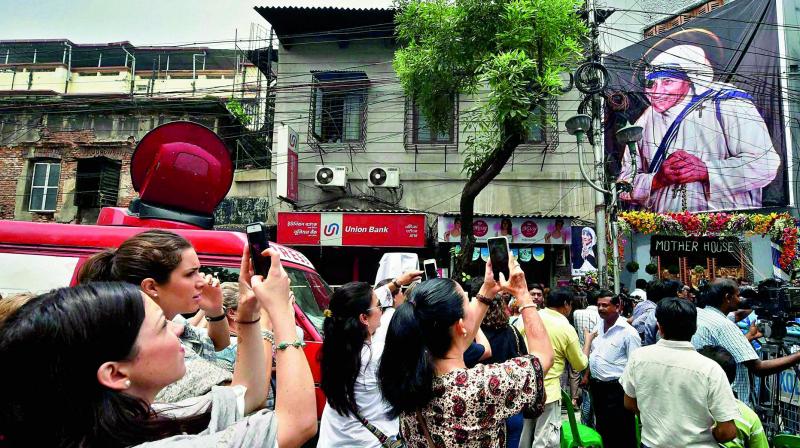 Tourists click photos in front of Mother’s House in Kolkata on Sunday during the canonization ceremony of Mother Teresa. (Photo: PTI) Tourists click photos in front of Mother’s House in Kolkata on Sunday during the canonization ceremony of Mother Teresa. (Photo: PTI)