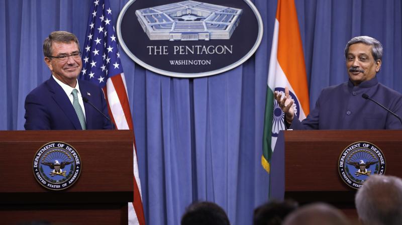 US Defense Secretary Ash Carter listens at left as Defence Minister Manohar Parrikar speaks during their joint news conference at the Pentagon. (Photo: AP) US Defense Secretary Ash Carter listens at left as Defence Minister Manohar Parrikar speaks during their joint news conference at the Pentagon. (Photo: AP)