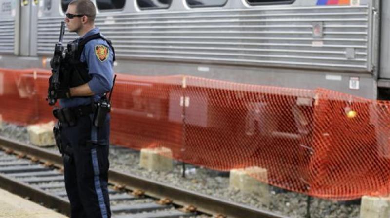 A New Jersey Transit Police officer stands guard near a train in New Jersey. (Photo: AP) A New Jersey Transit Police officer stands guard near a train in New Jersey. (Photo: AP)